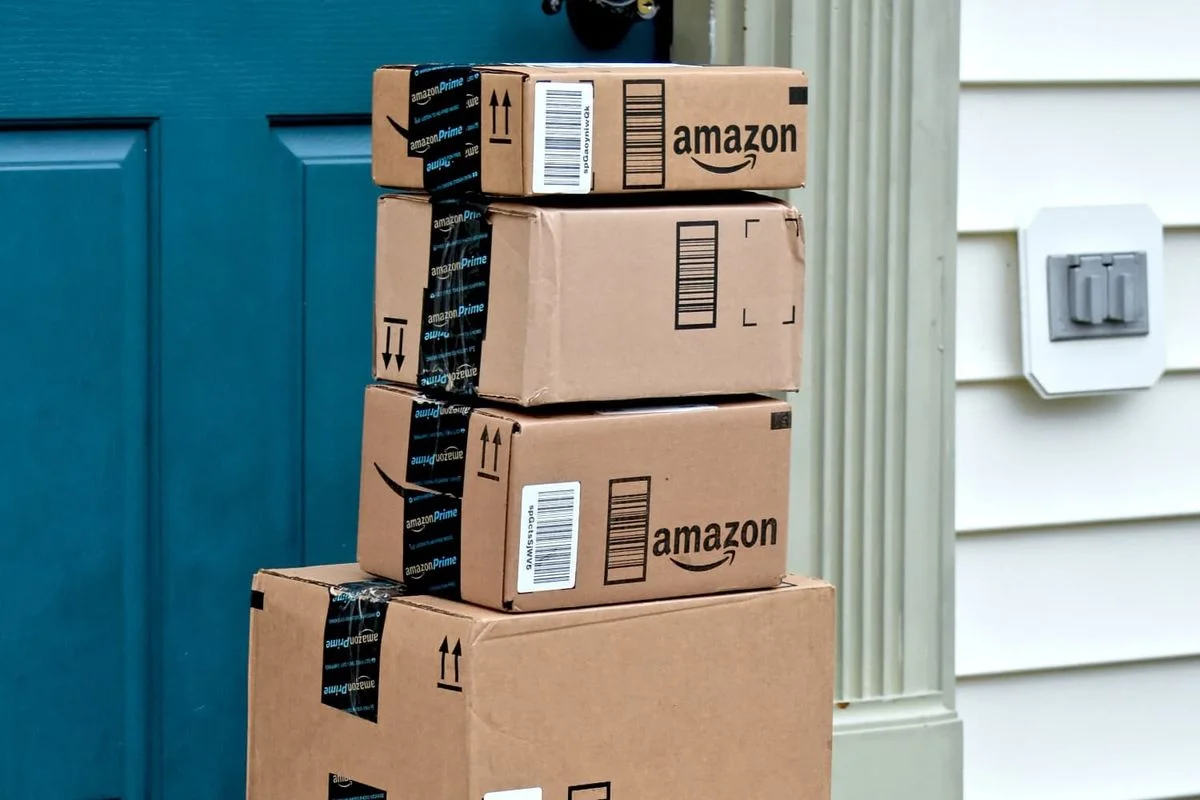 Amazon packages stacked near a front door